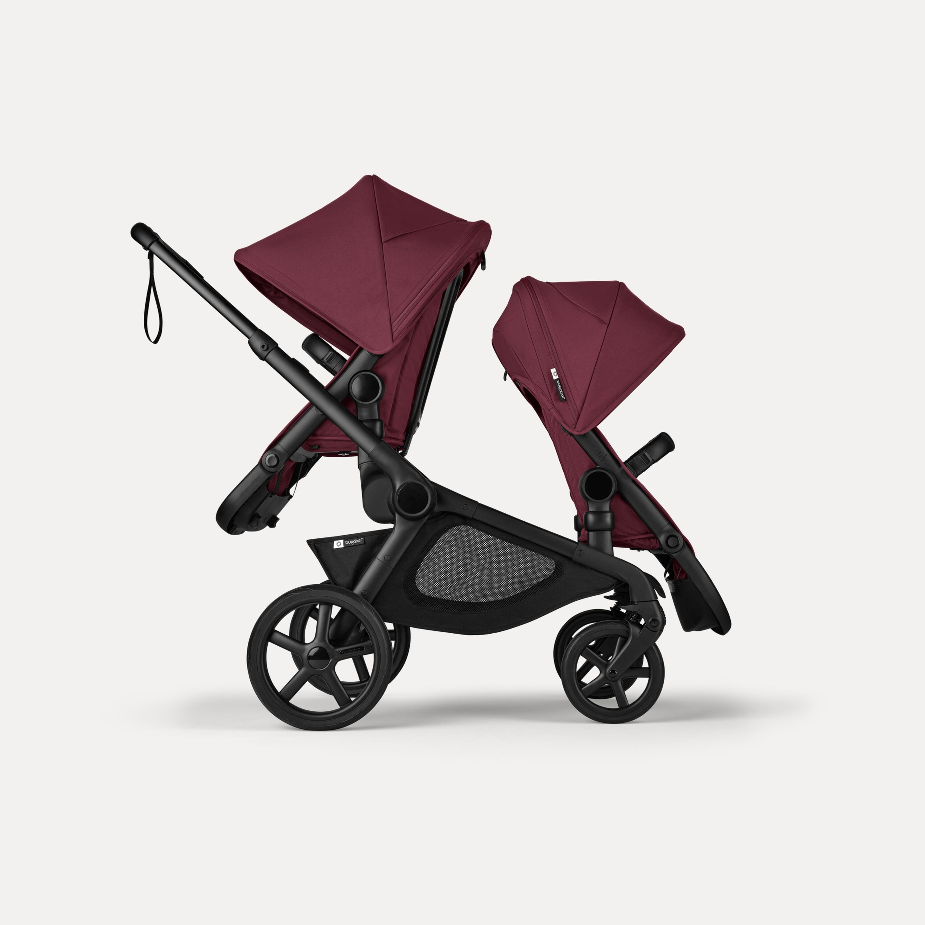 Side view of Bugaboo Kangaroo 2-in-1 tandem stroller with two seats, one facing parent and the other facing the world, with Dark Cherry fabrics and Dark Cherry sun canopies. - Main Modal Image Slide 4 of 18