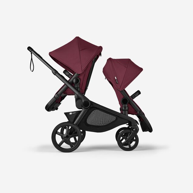 Side view of Bugaboo Kangaroo 2-in-1 tandem stroller with two seats, one facing parent and the other facing the world, with Dark Cherry fabrics and Dark Cherry sun canopies. - Main Image Slide 4 of 18