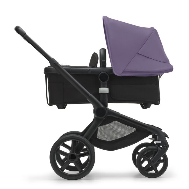 Side view of the Bugaboo Fox 5 bassinet stroller with black chassis, midnight black fabrics and astro purple sun canopy.