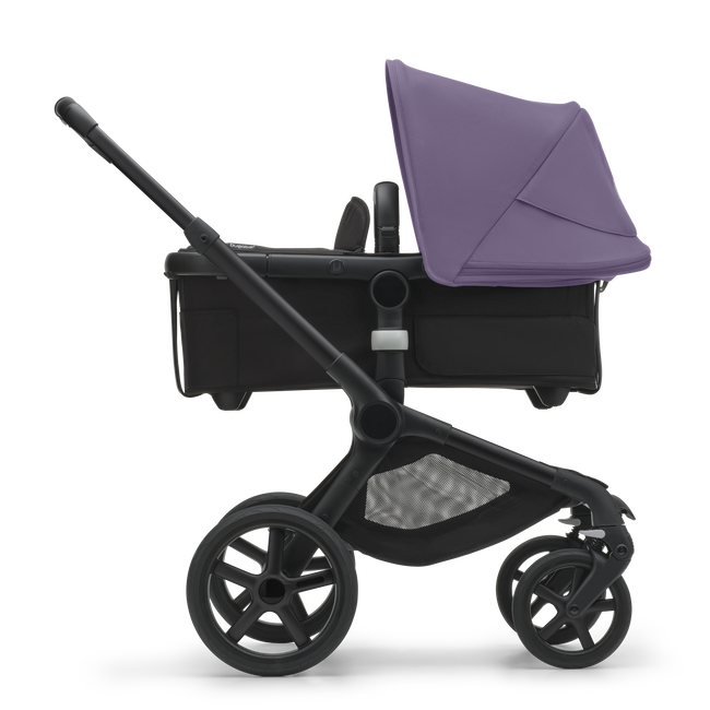 Side view of the Bugaboo Fox 5 bassinet stroller with black chassis, midnight black fabrics and astro purple sun canopy.