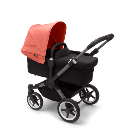 Bugaboo Donkey 5 Mono bassinet stroller with graphite chassis, midnight black fabrics and sunrise red sun canopy.