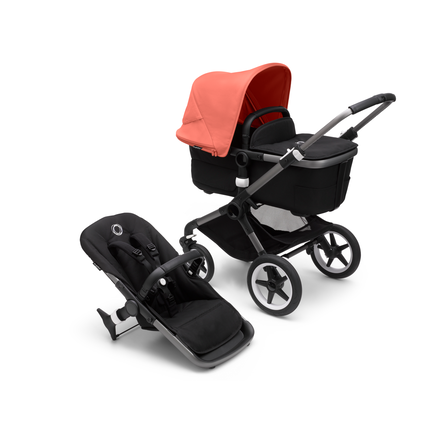 Bugaboo Fox 3 carrycot and seat pushchair with graphite frame, black fabrics, and red sun canopy.