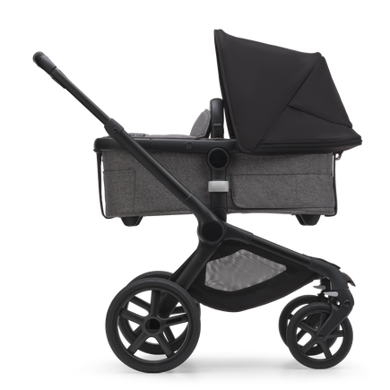 Side view of the Bugaboo Fox 5 carrycot pushchair with black chassis, grey melange fabrics and midnight black sun canopy. - view 2