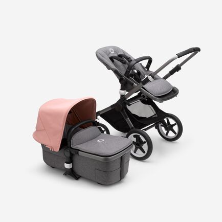 Bugaboo Fox 3 bassinet and seat stroller with graphite frame, grey fabrics, and pink sun canopy.