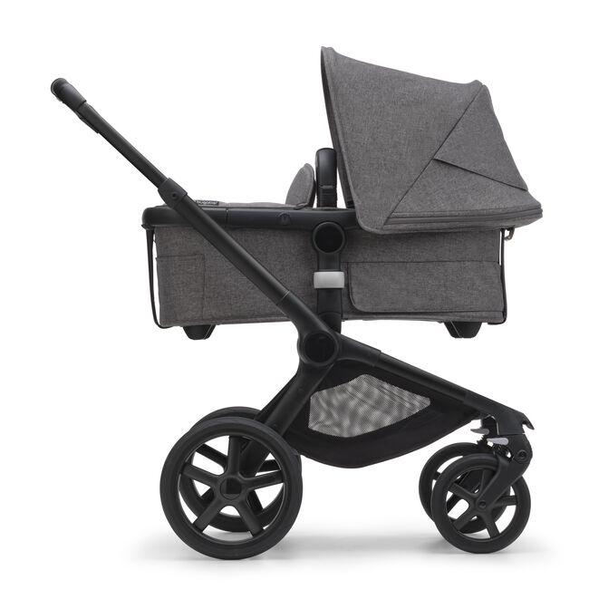 Side view of the Bugaboo Fox 5 bassinet stroller with black chassis, grey melange fabrics and grey melange sun canopy. - Main Image Slide 2 of 15