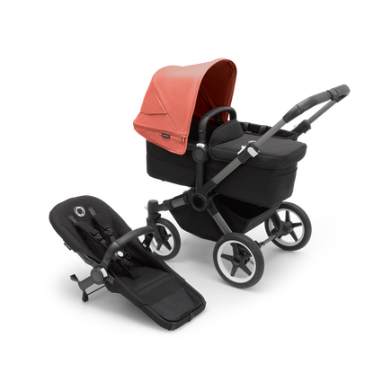 Bugaboo Donkey 5 Mono bassinet stroller with graphite chassis, midnight black fabrics and sunrise red sun canopy, plus seat.