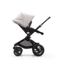Side view of a Bugaboo Fox 3 seat stroller with black frame, black fabrics, and white sun canopy. - Thumbnail Slide 8 of 9