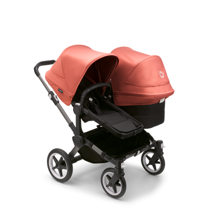 Bugaboo Donkey 5 Duo seat and bassinet stroller with graphite chassis, midnight black fabrics and sunrise red sun canopy.