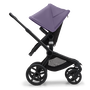 Side view of the Bugaboo Fox 5 seat stroller with black chassis, midnight black fabrics and astro purple sun canopy. - Thumbnail Slide 4 of 15