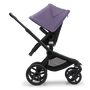 Side view of the Bugaboo Fox 5 seat stroller with black chassis, midnight black fabrics and astro purple sun canopy.