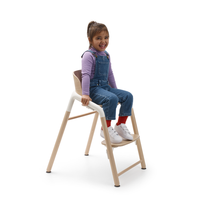 Child in a Bugaboo Giraffe chair.