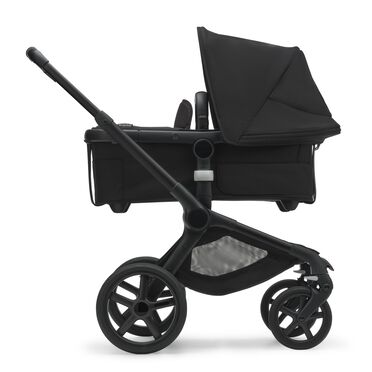 Side view of the Bugaboo Fox 5 carrycot pushchair with black chassis, midnight black fabrics and midnight black sun canopy. - view 2