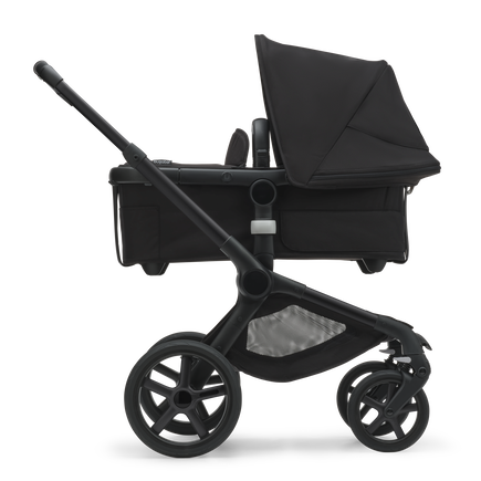 Side view of the Bugaboo Fox 5 carrycot pushchair with black chassis, midnight black fabrics and midnight black sun canopy. - view 2