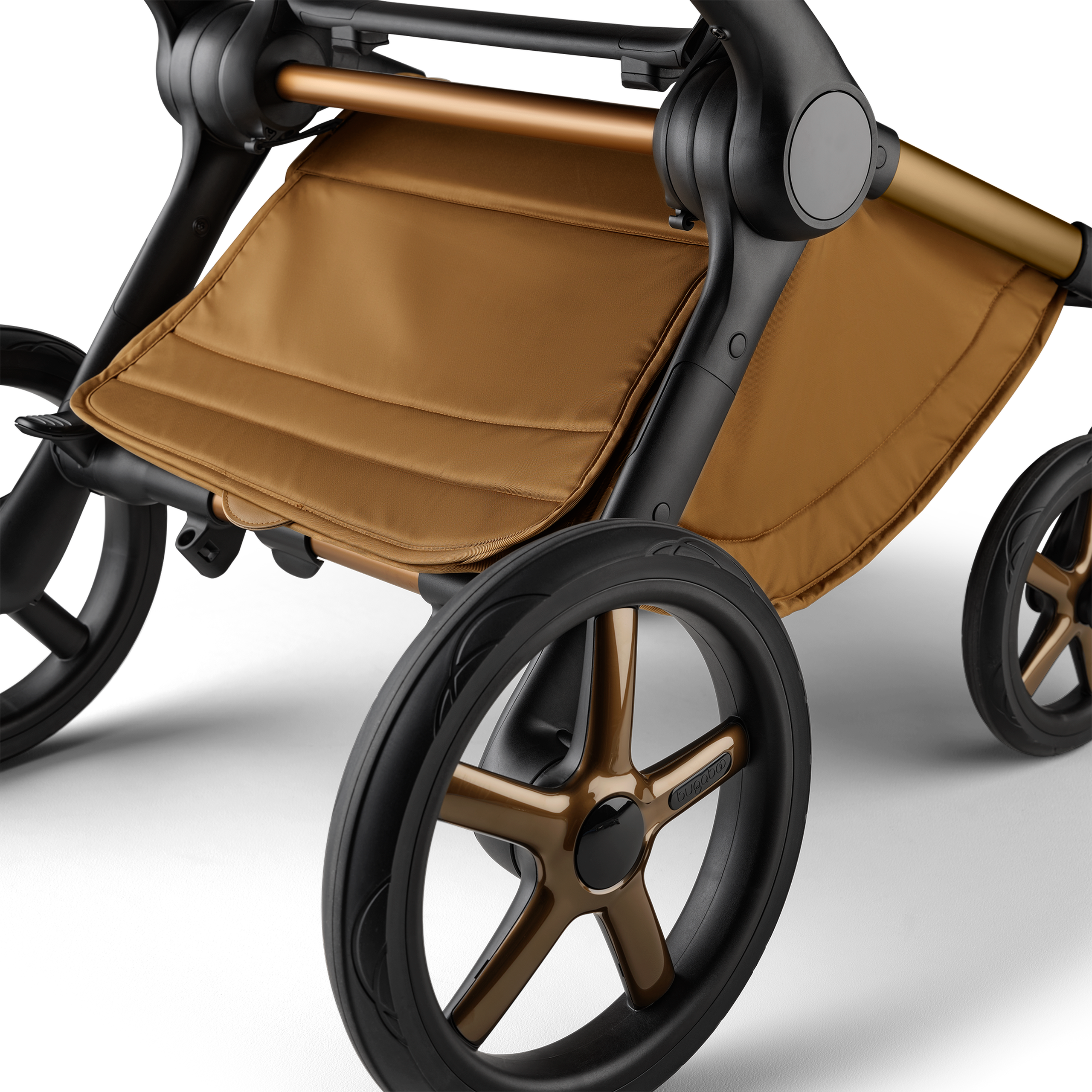 A close up of the underseat basket of the Bugaboo Fox 5 Noir Limited Edition stroller in Amber Glow. - Thumbnail Slide 6 of 15