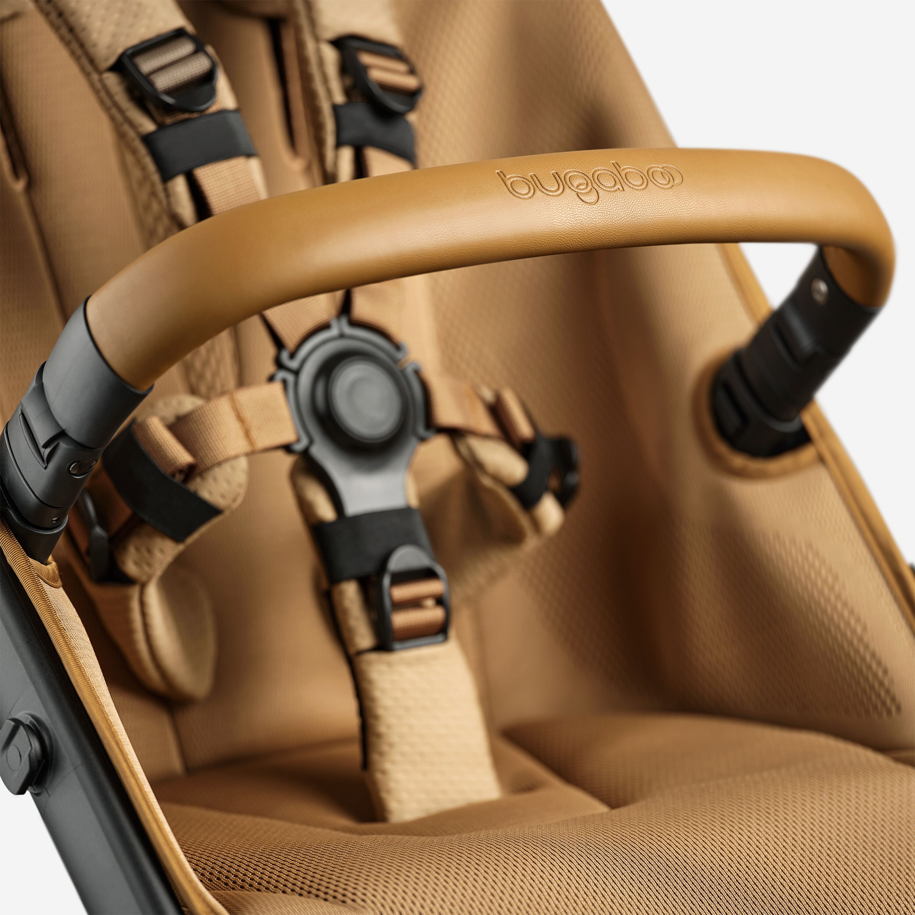 A close up of the bumper bar and seat of the Bugaboo Fox 5 Noir Limited Edition Amber Glow. - Main Modal Image Slide 13 of 15