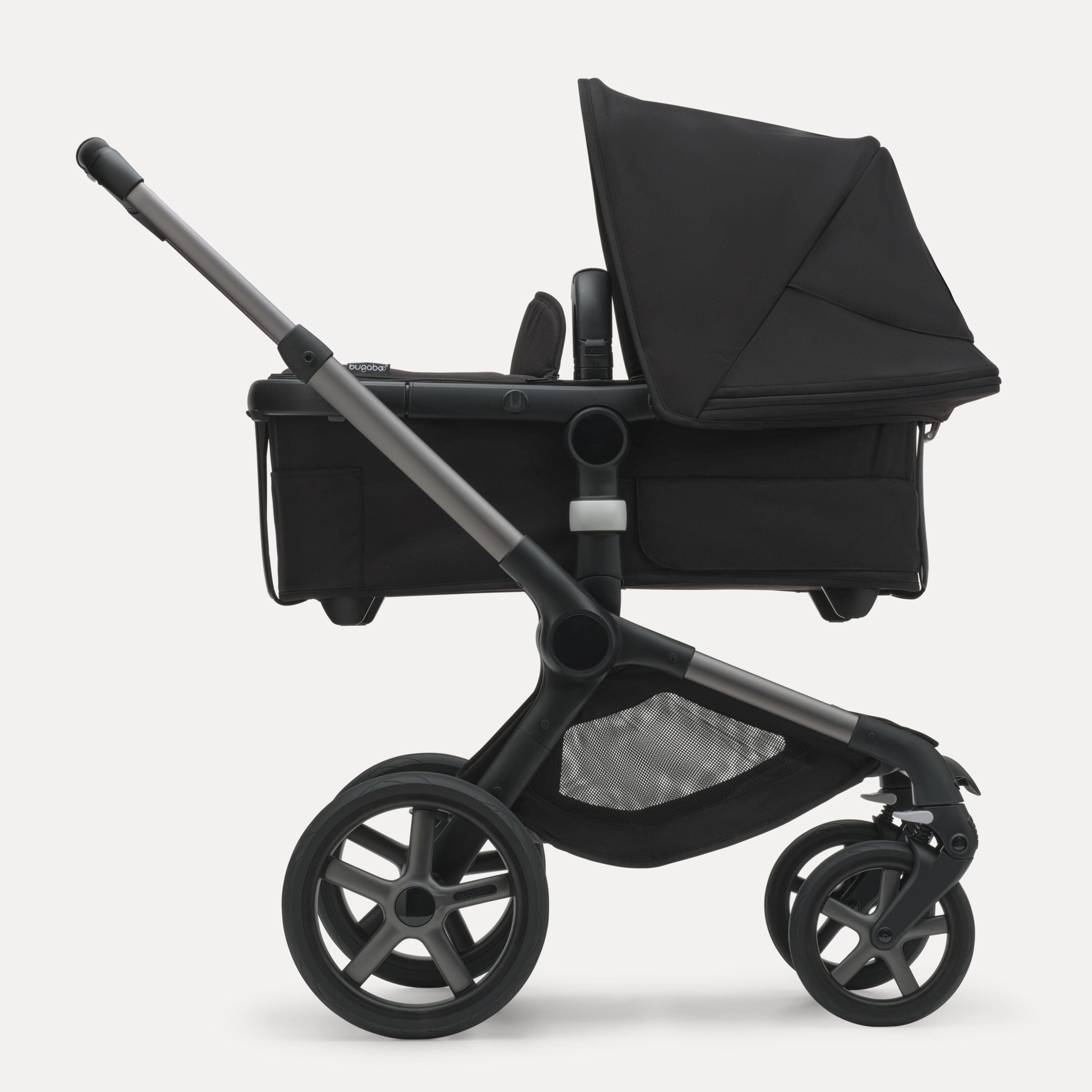 Side view of the Bugaboo Fox 5 bassinet stroller with graphite chassis, midnight black fabrics and midnight black sun canopy. - Main Modal Image Slide 2 of 13