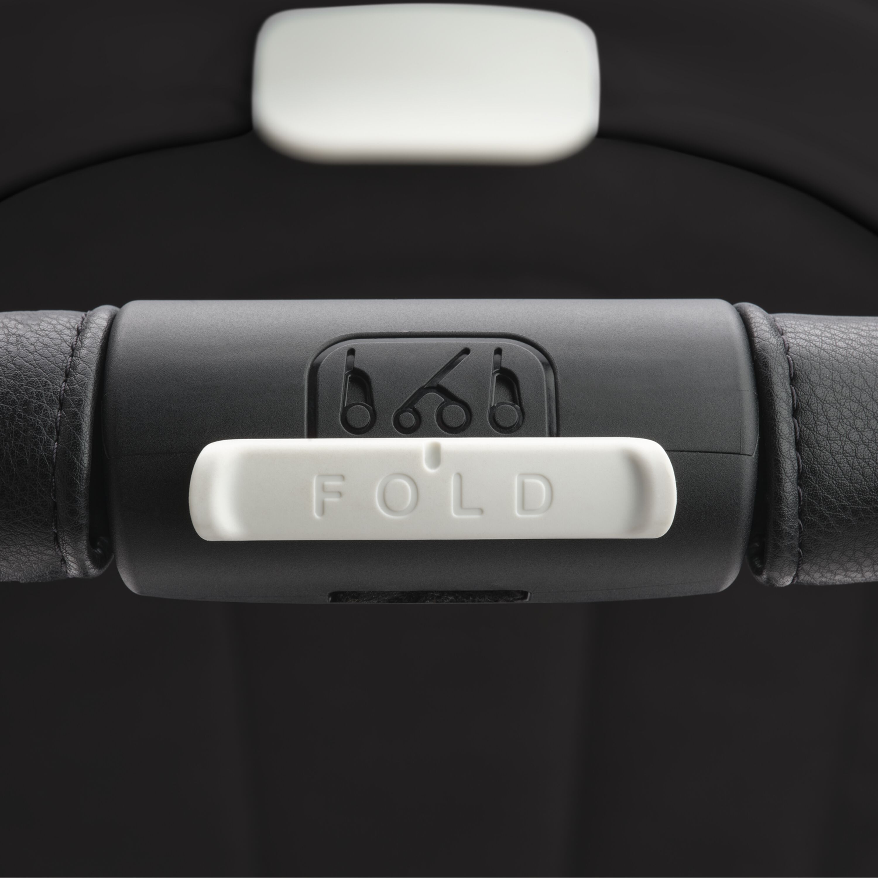 Close up on the Bugaboo Dragonfly stroller's handlebar, focusing on the big white 'Fold' button. - Main Modal Image Slide 14 of 16