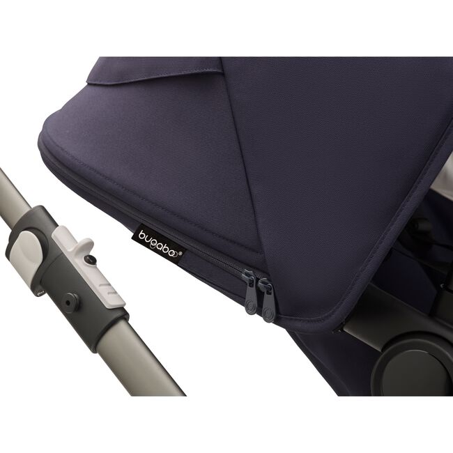 Close up of a Fox 3 dark navy sun canopy with the Bugaboo logo tag.