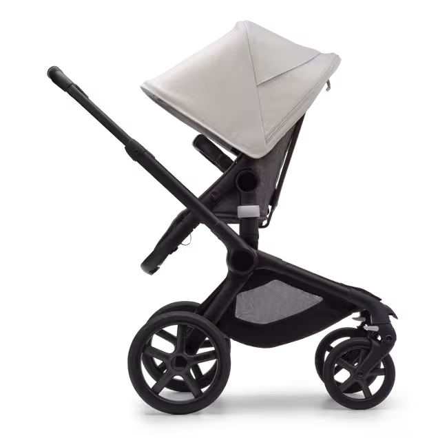 Side view of the Bugaboo Fox 5 seat pushchair with black chassis, grey melange fabrics and misty white sun canopy. - Main Image Slide 3 of 13