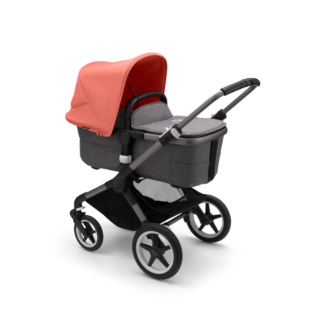 Bugaboo Fox 3 bassinet stroller with graphite frame, grey fabrics, and red sun canopy.