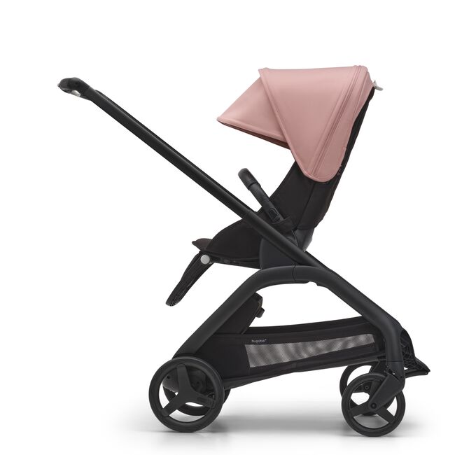 Side view of the Bugaboo Dragonfly seat stroller with black chassis, midnight black fabrics and morning pink sun canopy. - Main Image Slide 3 of 18