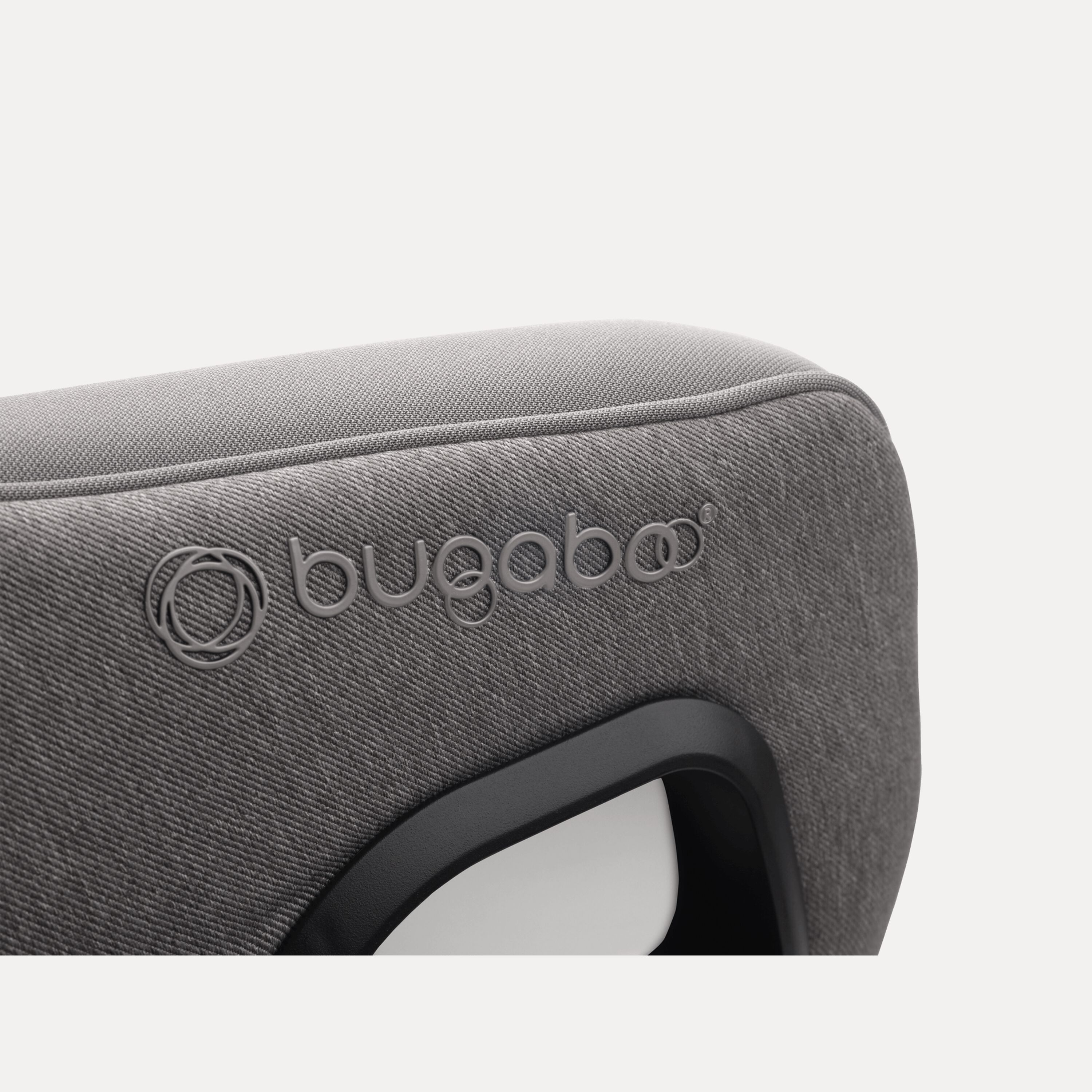 Close up of the embossed Bugaboo logo on the Bugaboo Owl by Nuna car seat in grey fabrics. - Main Modal Image Slide 10 of 11