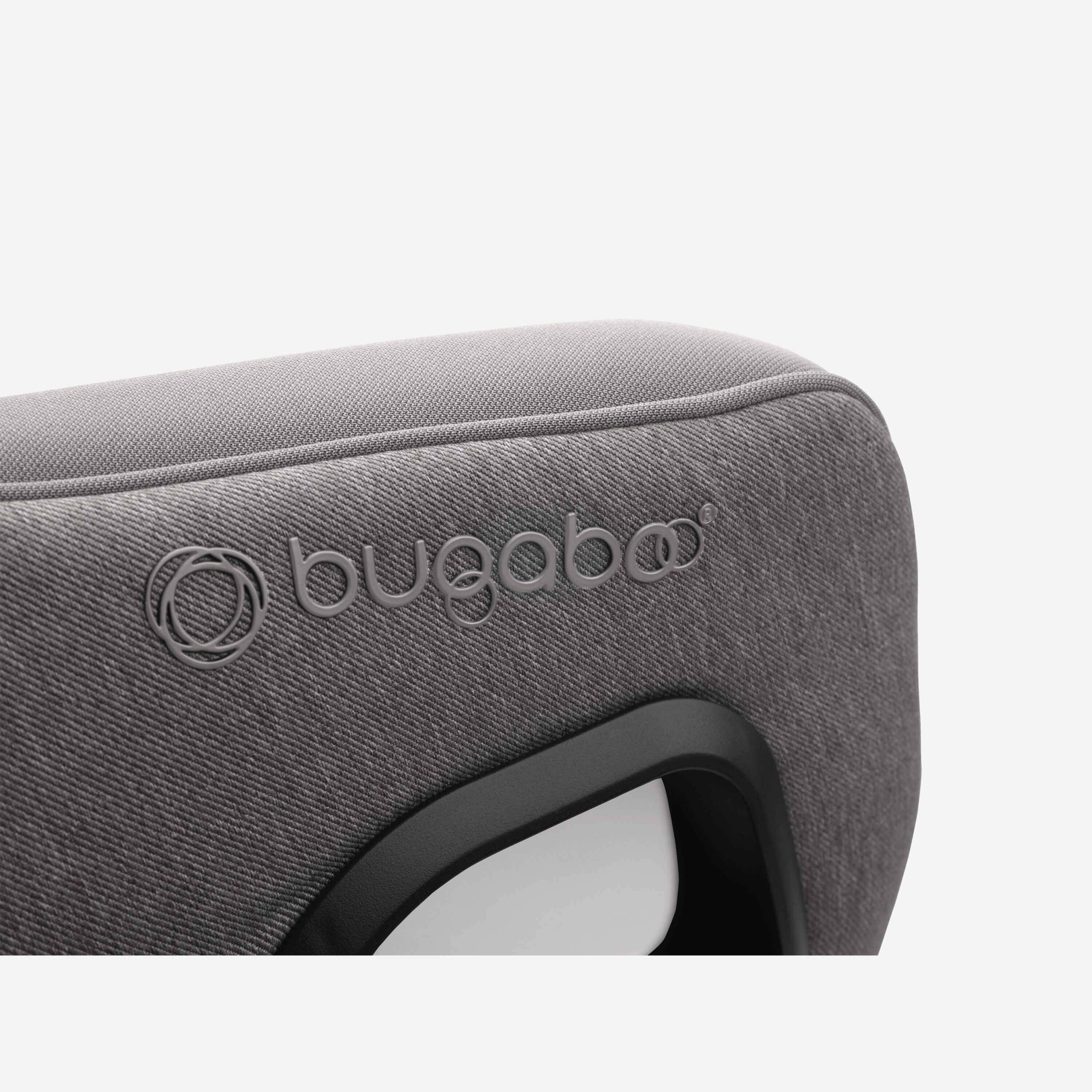 Close up of the embossed Bugaboo logo on the Bugaboo Owl by Nuna car seat in grey fabrics. - Main Modal Image Slide 10 of 11