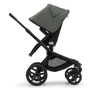 Side view of the Bugaboo Fox 5 seat stroller with black chassis, midnight black fabrics and forest green sun canopy. - Thumbnail Modal Image Slide 4 of 15