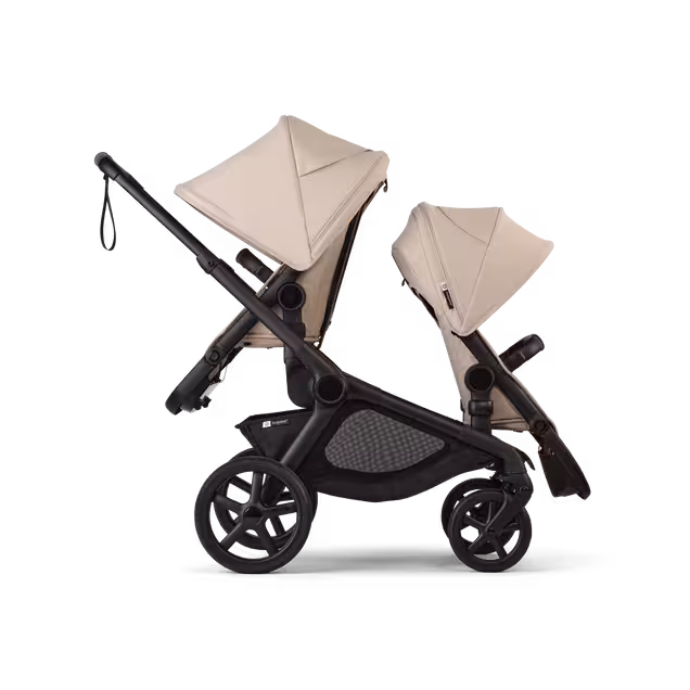 Side view of Bugaboo Kangaroo 2-in-1 tandem stroller with two seats, one facing parent and the other facing the world, with Desert Taupe fabrics and Desert Taupe sun canopies. - Main Image Slide 4 of 18