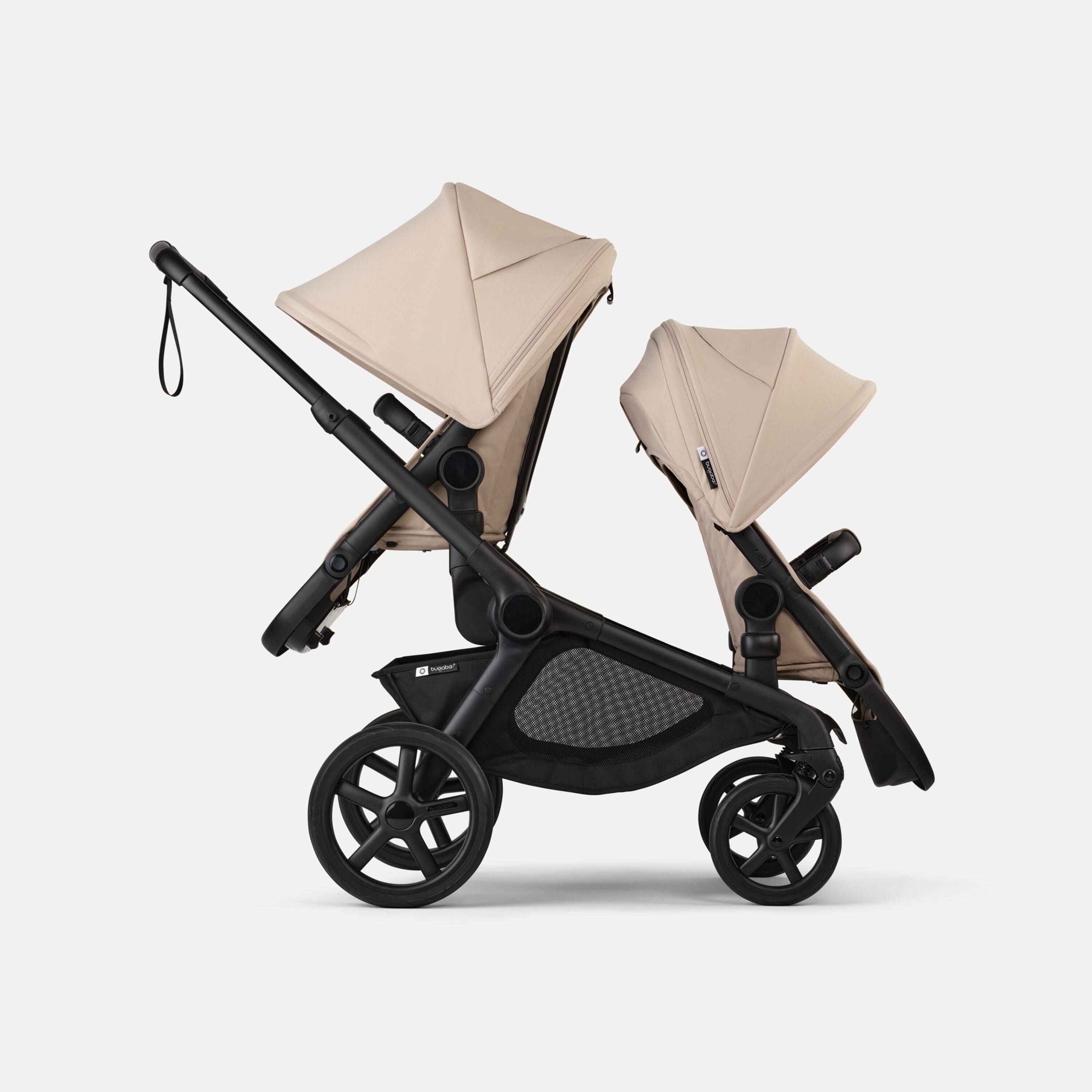 Side view of Bugaboo Kangaroo 2-in-1 tandem stroller with two seats, one facing parent and the other facing the world, with Desert Taupe fabrics and Desert Taupe sun canopies. - Main Modal Image Slide 4 of 18