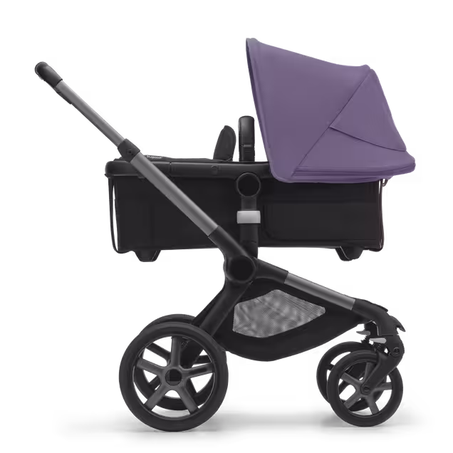 Side view of the Bugaboo Fox 5 bassinet stroller with graphite chassis, midnight black fabrics and astro purple sun canopy. - Main Image Slide 2 of 13