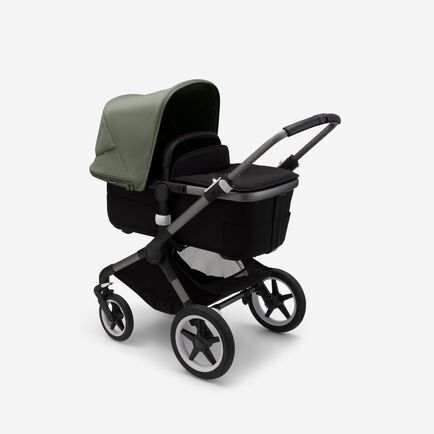 Bugaboo Fox 3 bassinet stroller with graphite frame, black fabrics, and forest green sun canopy.