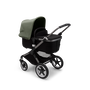 Bugaboo Fox 3 bassinet stroller with graphite frame, black fabrics, and forest green sun canopy.