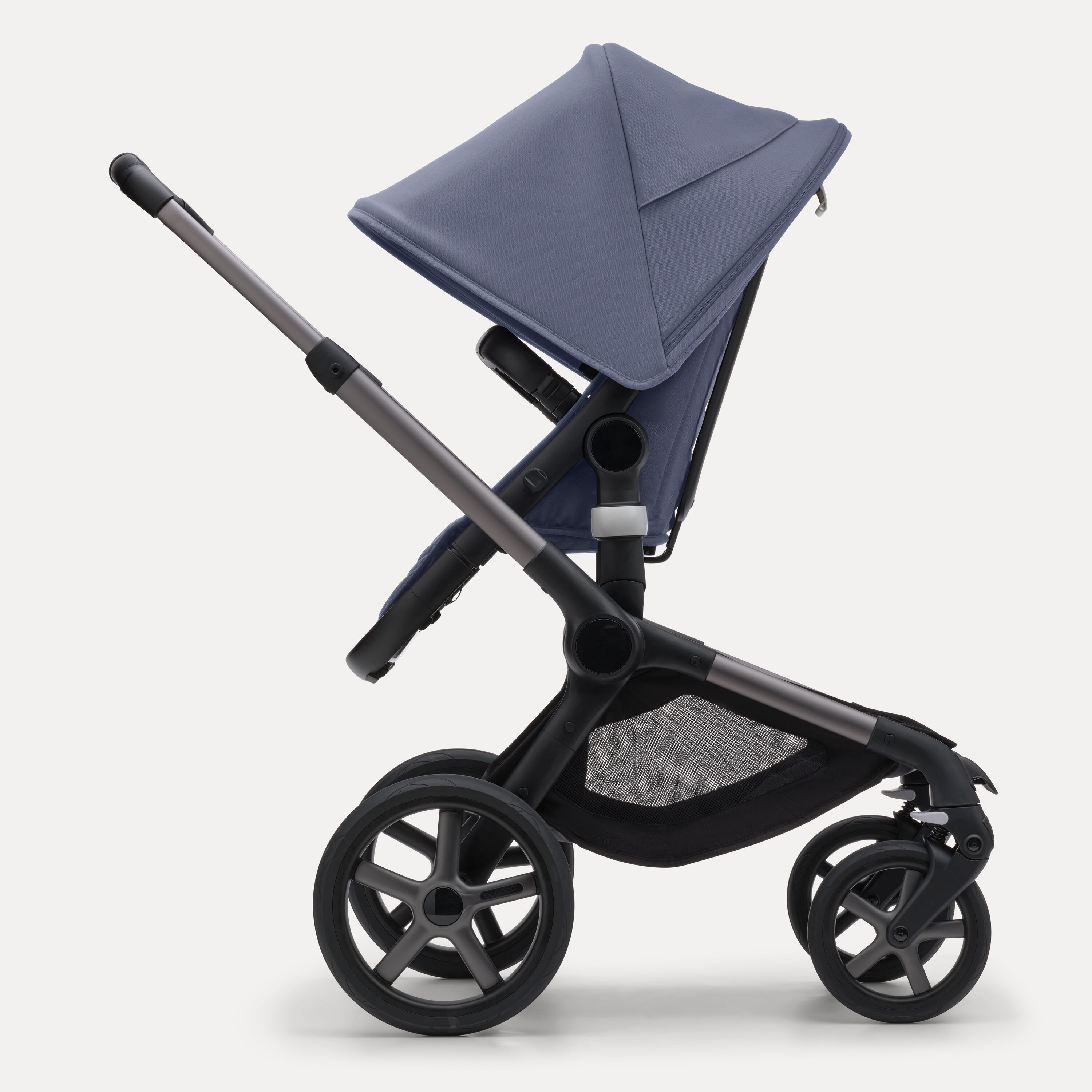 Side view of the Bugaboo Fox 5 seat stroller with graphite chassis, midnight black fabrics and stormy blue sun canopy. - Main Modal Image Slide 3 of 12