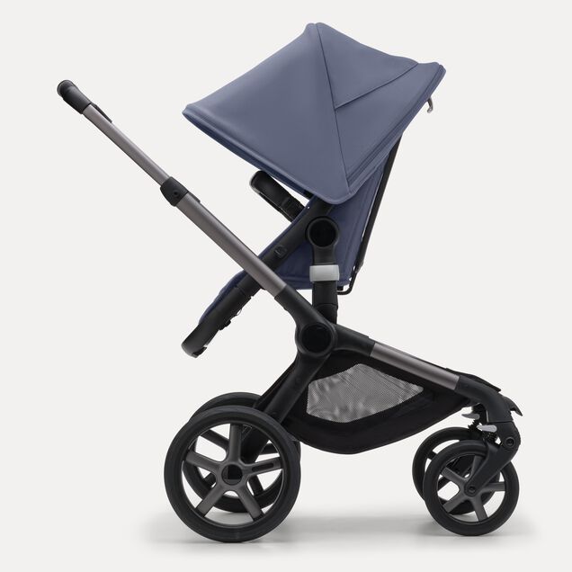 Side view of the Bugaboo Fox 5 seat stroller with graphite chassis, midnight black fabrics and stormy blue sun canopy. - Main Image Slide 3 of 12