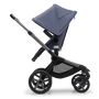 Side view of the Bugaboo Fox 5 seat stroller with graphite chassis, midnight black fabrics and stormy blue sun canopy. - Thumbnail Slide 4 of 14