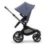 Side view of the Bugaboo Fox 5 seat stroller with graphite chassis, midnight black fabrics and stormy blue sun canopy.