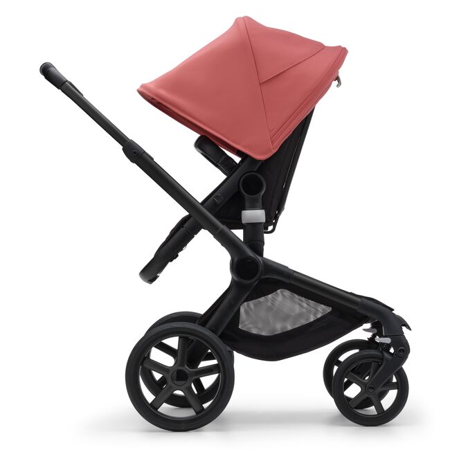 Side view of the Bugaboo Fox 5 seat pushchair with black chassis, midnight black fabrics and sunrise red sun canopy. - Main Image Slide 4 of 16
