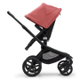 Side view of the Bugaboo Fox 5 seat pushchair with black chassis, midnight black fabrics and sunrise red sun canopy. - Thumbnail Slide 4 of 16