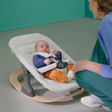 Baby in a Bugaboo rocker, with newborn set in white fabrics. - view 2
