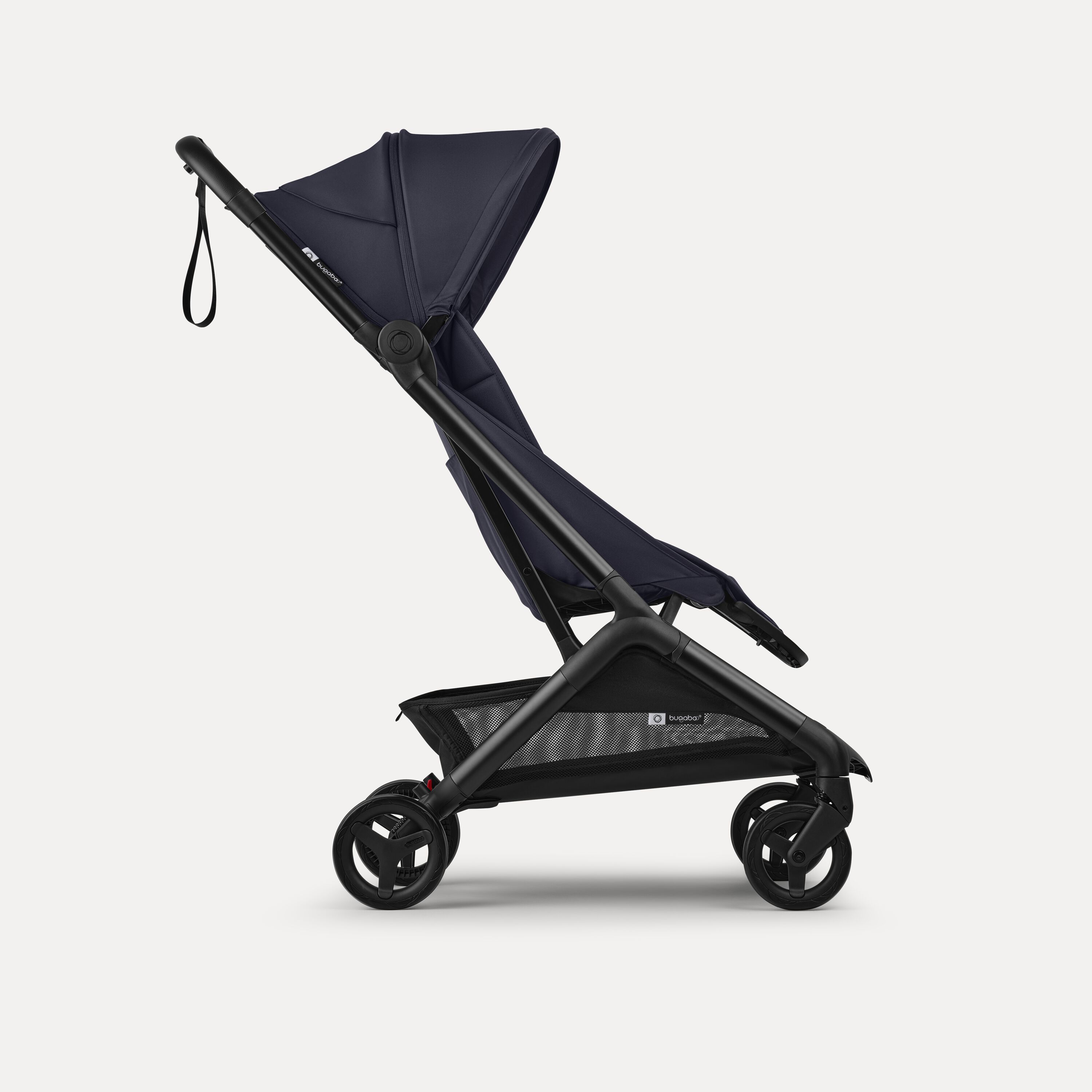 Side view of a Bugaboo Butterfly 2 ultra-compact travel pram with black chassis, Deep Indigo fabrics, and Deep Indigo sun canopy. - Main Modal Image Slide 2 of 9