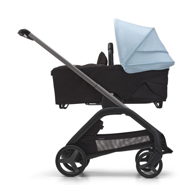 Side view of the Bugaboo Dragonfly bassinet stroller with graphite chassis, midnight black fabrics and skyline blue sun canopy.