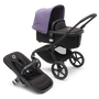 Bugaboo Fox 5 bassinet and seat stroller with black chassis, midnight black fabrics and astro purple sun canopy.