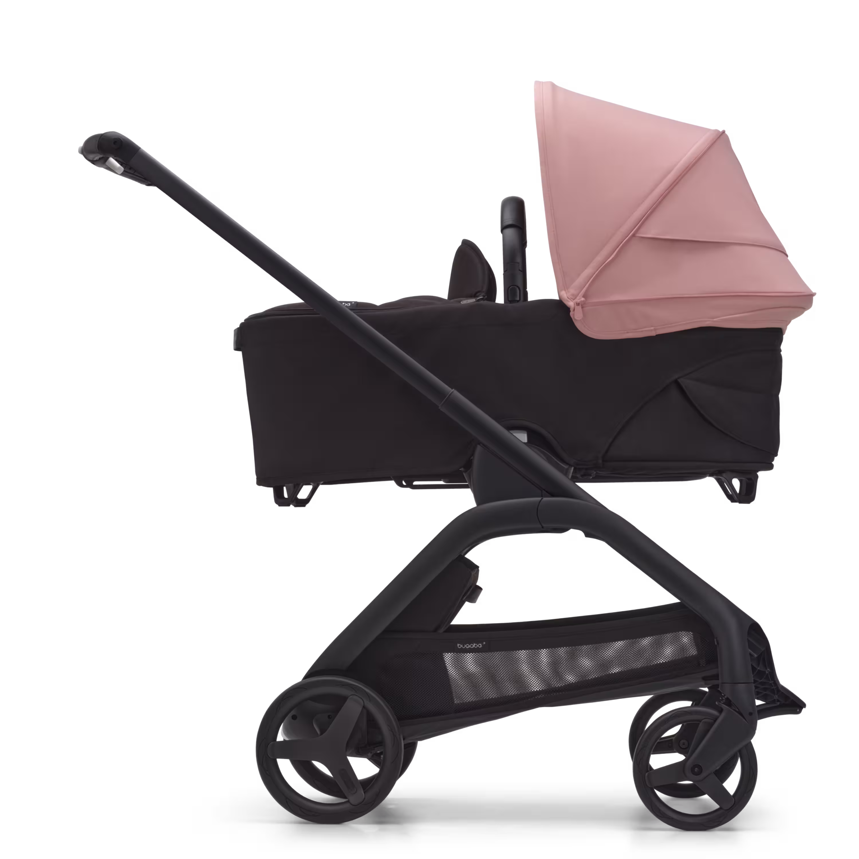 Side view of the Bugaboo Dragonfly bassinet stroller with black chassis, midnight black fabrics and morning pink sun canopy. - Main Modal Image Slide 3 of 16