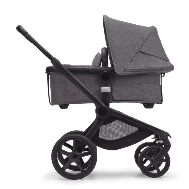 Side view of the Bugaboo Fox 5 carrycot pushchair with black chassis, grey melange fabrics and grey melange sun canopy. - Main Image Slide 2 of 13