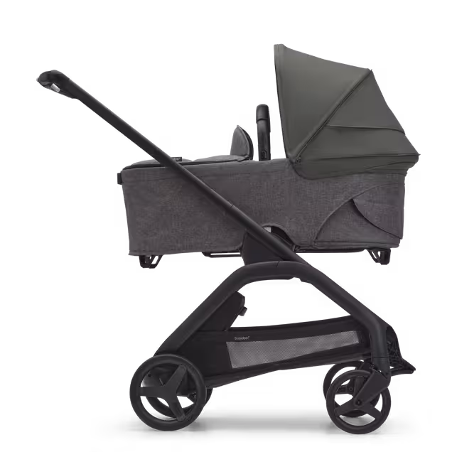Side view of the Bugaboo Dragonfly bassinet stroller with black chassis, grey melange fabrics and forest green sun canopy. - Main Image Slide 3 of 16