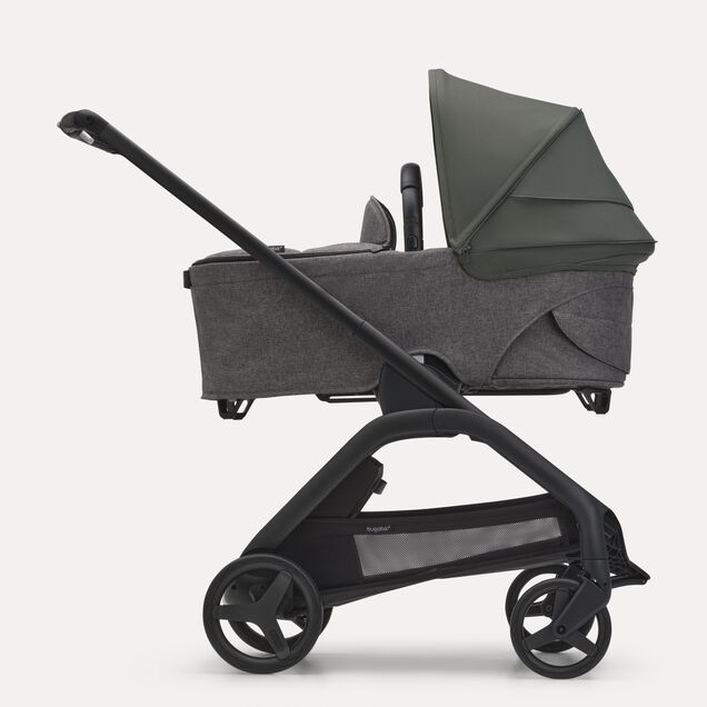 Side view of the Bugaboo Dragonfly bassinet stroller with black chassis, grey melange fabrics and forest green sun canopy. - Main Image Slide 3 of 16