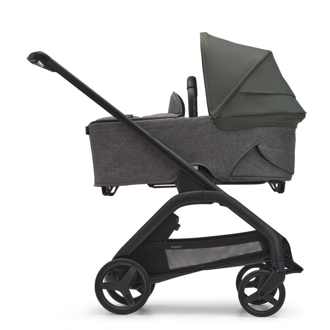 Side view of the Bugaboo Dragonfly bassinet stroller with black chassis, grey melange fabrics and forest green sun canopy. - Main Image Slide 4 of 18