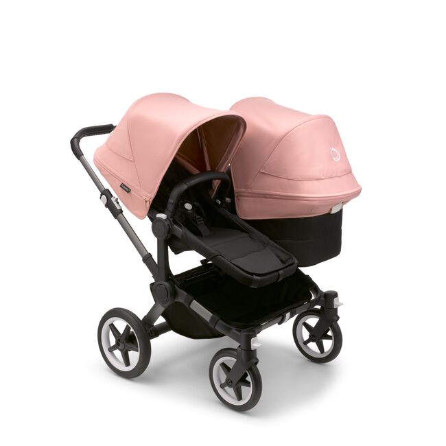 Bugaboo Donkey 5 Duo seat and bassinet stroller with graphite chassis, midnight black fabrics and morning pink sun canopy. - Main Image Slide 1 of 12