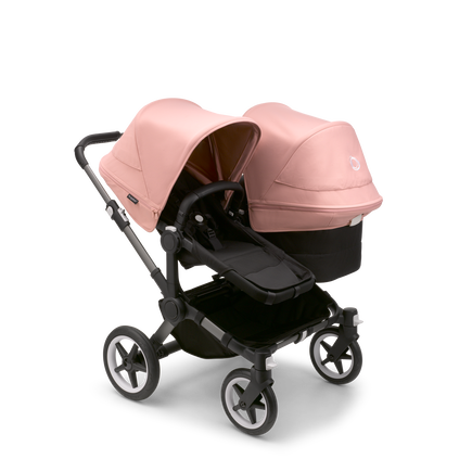 Bugaboo Donkey 5 Duo seat and bassinet stroller with graphite chassis, midnight black fabrics and morning pink sun canopy. - view 1